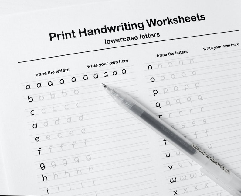 May include: A black and white printable handwriting worksheet for lowercase letters. The worksheet has two columns, one for tracing the letters and one for writing the letters. A clear pen is lying on top of the worksheet.