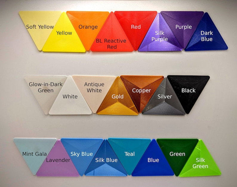 May include: A collection of 20 triangle-shaped plastic samples in various colors, including soft yellow, orange, red, purple, dark blue, glow-in-dark green, antique white, copper, black, white, gold, silver, mint gala, lavender, sky blue, teal, blue, and green. The samples are arranged in three rows.