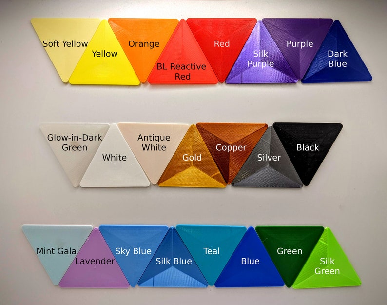 May include: A collection of 20 triangle-shaped plastic samples in various colors, including soft yellow, orange, red, purple, dark blue, glow-in-dark green, antique white, copper, black, white, gold, silver, mint gala, lavender, sky blue, teal, blue, and green. The samples are arranged in three rows.