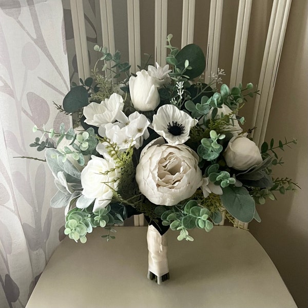 Classic bridal bouquet with ivory roses peonies and anemone accented with eucalyptus and fern greenery, matching bridesmaids boutonnieres