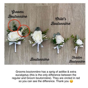 May include: Five white rose boutonni&egrave;res with greenery, displayed on a wood background. The boutonni&egrave;res are labeled "Grooms Boutonni&egrave;re", "Child's Boutonni&egrave;re", "Boutonni&egrave;re", and "Toddler Boutonni&egrave;re". The text "Grooms boutonni&egrave;re has a sprig of astilbe & extra eucalyptus (this is the only difference between the regular and Groom boutonni&egrave;re). They are circled in red so you can see the difference. Thank you" is written below the boutonni&egrave;res.