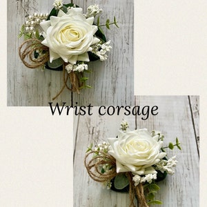 May include: A wrist corsage featuring a large white artificial rose, small white filler flowers, green leaves, a strand of white faux pearls, and loops of brown twine. The text "Wrist corsage" is printed in black below the top floral arrangement.