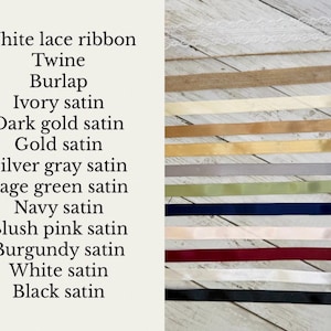 May include: A collection of ribbons and trims including white lace, twine, burlap, and satin in ivory, dark gold, gold, silver gray, sage green, navy, blush pink, burgundy, white, and black. The text lists each material and color variant shown.