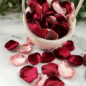 A mix of burgundy, and blush pink rose petals for flower girl petals, baskets, and memory or reception table scatter, backdrop accents, bridal shower decor. For the future bride planning a classic wedding ceremony or fall bridal brunch event.