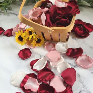 A mix of burgundy, ivory, and blush pink rose petals for flower girl petals, rustic baskets, memory or reception table scatter, backdrop accents, bridal shower decor. For the future bride planning a classic wedding ceremony or fall bridal brunch event.