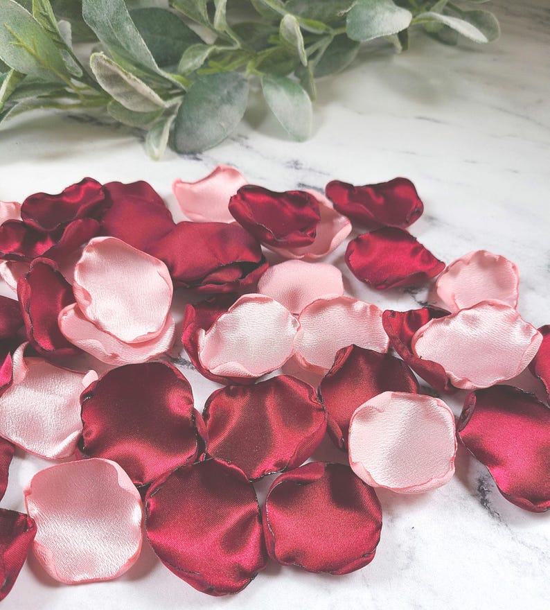 A mix of burgundy, and blush pink rose petals for flower girl petals, baskets, and memory or reception table scatter, backdrop accents, bridal shower decor. For the future bride planning a classic wedding ceremony or fall bridal brunch event.
