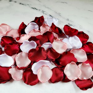 A mix of burgundy, white, and blush pink rose petals for flower girl petals, baskets, memory or reception table scatter, backdrop accents, bridal shower decor. For the future bride planning a classic wedding ceremony or fall bridal brunch event.