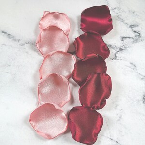 A mix of burgundy, ivory, and blush pink rose petals for flower girl petals, baskets, and memory or reception table scatter, backdrop accents, bridal shower decor. For the future bride planning a classic wedding ceremony or fall bridal brunch event.