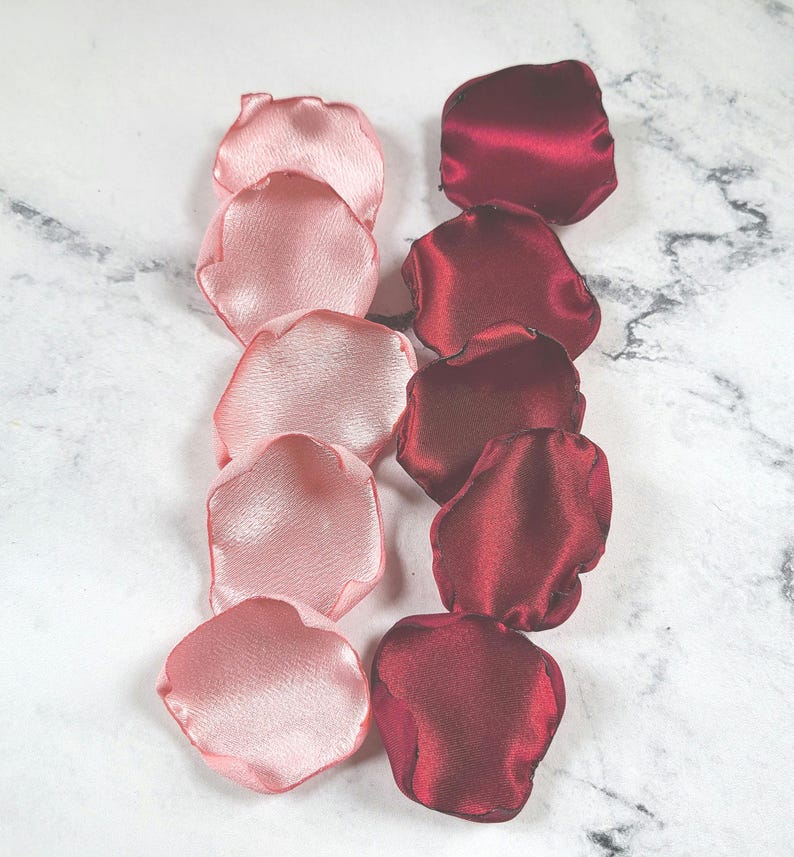 A mix of burgundy, ivory, and blush pink rose petals for flower girl petals, baskets, and memory or reception table scatter, backdrop accents, bridal shower decor. For the future bride planning a classic wedding ceremony or fall bridal brunch event.