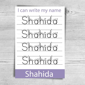 May include: A white worksheet with the text "I can write my name" at the top. The name "Shahida" is written in dotted lines for tracing practice. The name is also written in a purple rectangle at the bottom.