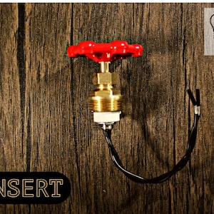 May include: A red and brass light switch with a round, red knob. The switch is mounted on a wooden surface. The wires are visible and are black. The text "EDISON LOGIC" is visible in the upper right corner of the image.