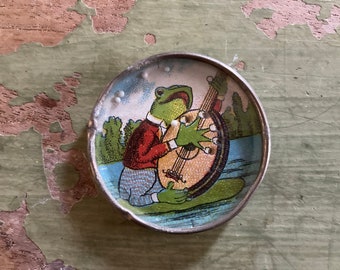 Vintage anthropomorphic frog playing banjo dexterity puzzle