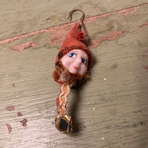 Vintage Christmas elf with plastic face and flocked paper hat