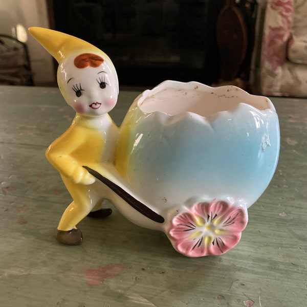 Vintage Lefton or Hull pixie or elf planter with an Easter egg cart with flower wheels