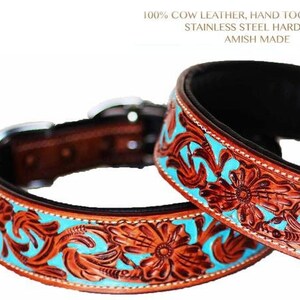 May include: Two brown leather dog collars with turquoise floral tooling. The collars are padded and have stainless steel hardware. The text "100% COW LEATHER, HAND TOOLED, PADDED STAINLESS STEEL HARDWARE AMISH MADE" is visible above the collars.