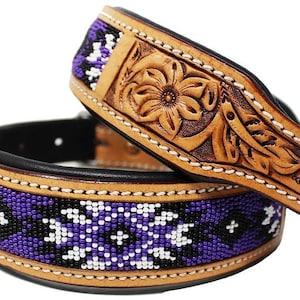 May include: A brown leather dog collar with a floral design and a purple, white, and black beaded trim.