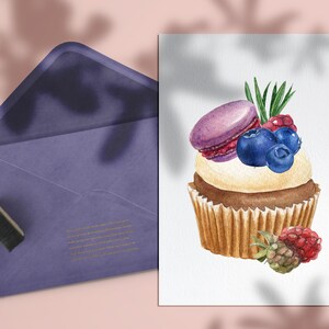 May include: Watercolor illustration of a cupcake topped with a purple macaron, blueberries, and raspberries. A purple envelope and stamp are in the background. The cupcake has a white frosting and a brown base.