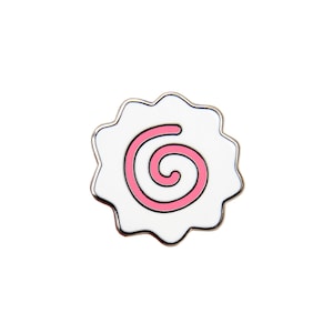 May include: A white enamel pin with a pink swirl design. The pin is shaped like a Japanese fish cake, known as kamaboko.