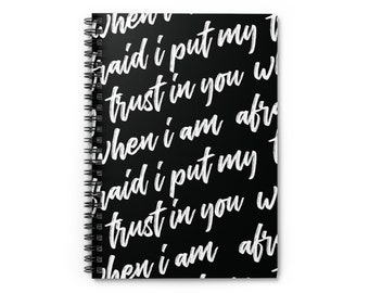 May include: Black spiral notebook with white text that reads "When I am afraid I put my trust in you when I am afraid I put my trust in you when I am afraid I put my trust in you".