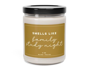 May include: A 9 oz candle in a clear glass jar with a black lid. The label is gold with white text that reads "Smells Like family study night" and "Olive + Fig Co."