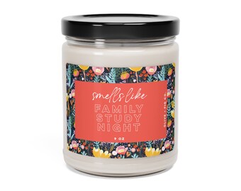 May include: A 9 oz candle with a floral design label. The label reads "smells like FAMILY STUDY NIGHT" in white text on a red background. The candle is in a clear glass jar with a black lid.