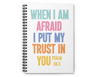 May include: A white spiral notebook with the text "WHEN I AM AFRAID I PUT MY TRUST IN YOU PSALM 56:3" in colorful text.