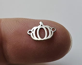 May include: A silver metal charm in the shape of a crown. The crown has a rounded top and a pointed tip.