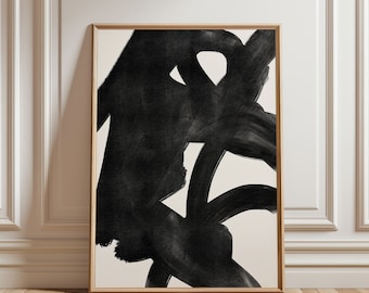 May include: Abstract art print featuring bold black brushstrokes on a cream background, framed in a natural wood. The artwork's dynamic composition creates a striking visual contrast, perfect for modern home decor.