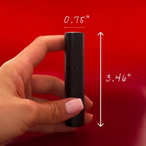 May include: A black refillable perfume atomizer bottle with a silver cap. The bottle is 3.46 inches tall and 0.75 inches wide.