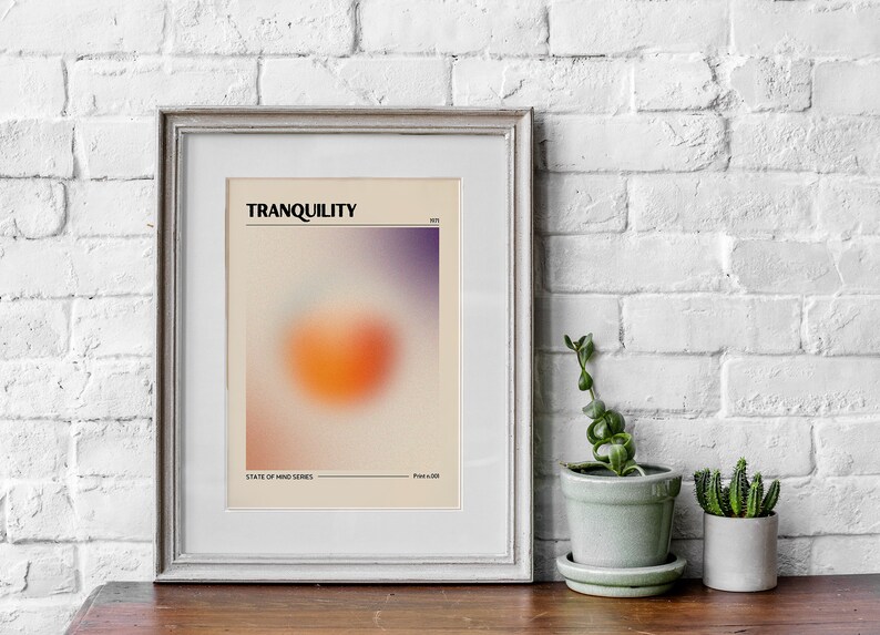 May include: A framed print with a blurred orange and purple gradient design. The print has the text "TRANQUILITY" and "STATE OF MIND SERIES" at the top and bottom.
