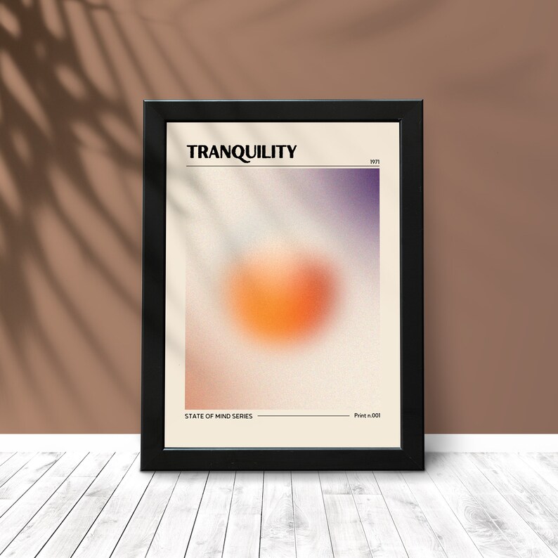 May include: A framed poster with a blurred orange and purple gradient background. The text "TRANQUILITY" is at the top of the poster, with the text "STATE OF MIND SERIES" at the bottom.
