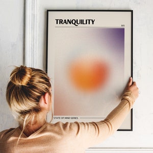May include: A framed poster with a blurred orange and purple gradient design. The poster is titled "TRANQUILITY" and includes the text "STATE OF MIND SERIES" and "1971".