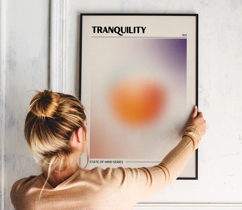 May include: A framed poster with a blurred orange and purple gradient design. The poster is titled "TRANQUILITY" and includes the text "STATE OF MIND SERIES" and "1971".