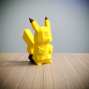 May include: A yellow origami Pikachu figurine with black ears and a black tail. The figurine is standing on a wooden surface.
