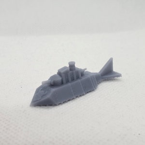 Puede incluir: Un modelo gris de submarino futurista impreso en 3D con una cola de aleta y una torreta en la parte superior.