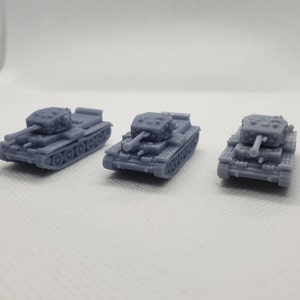 May include: Three grey plastic toy tanks with detailed features, including a turret, wheels, and a cannon.