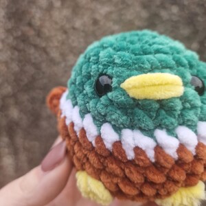 Close-up of handmade crochet mallard duck plush showing soft chenille yarn texture
