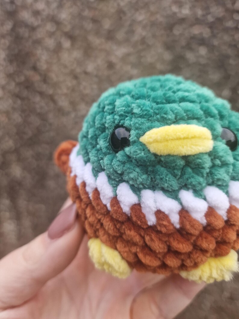 Close-up of handmade crochet mallard duck plush showing soft chenille yarn texture