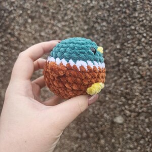 Back view of crochet mallard duck plush toy showing brown body and wings