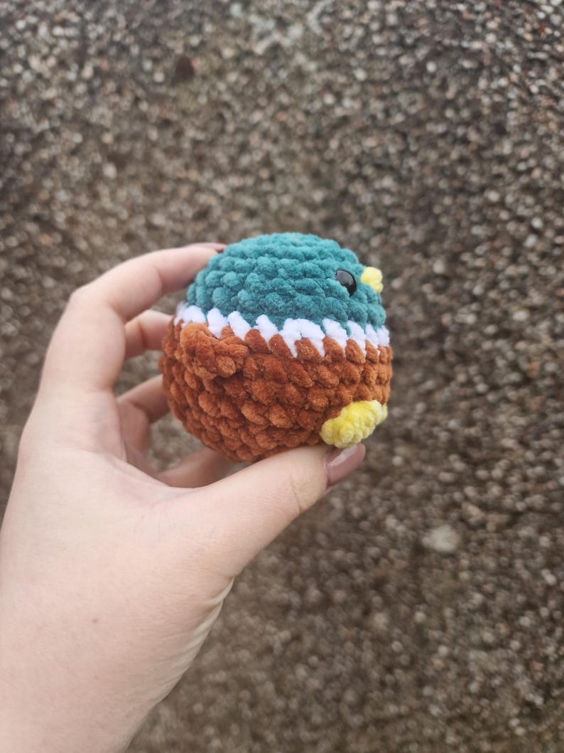 Back view of crochet mallard duck plush toy showing brown body and wings
