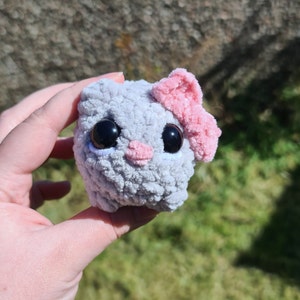 Sad hamster as featured on TikTok meme videos. Silver in colour with large black eyes, pink nose and pink bow on its ear