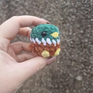 Side view of tiny handmade crochet mallard duck plush showing wings
