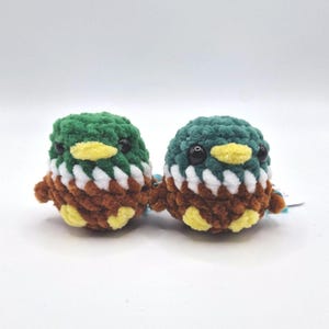 Two tiny handmade mallard duck plush toys displayed together