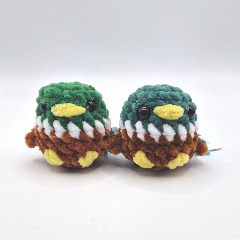 Two tiny handmade mallard duck plush toys displayed together