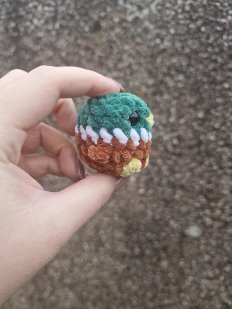 Back view of small amigurumi mallard duck plush toy