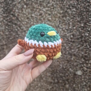 Side view of handmade crochet mallard duck plush toy with wings