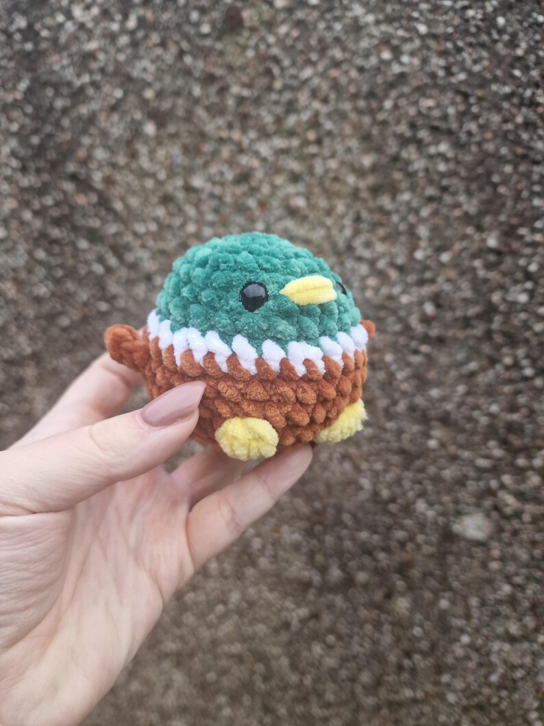 Side view of handmade crochet mallard duck plush toy with wings