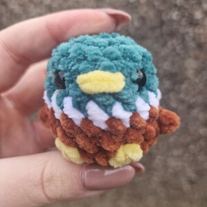 Close-up of handmade amigurumi mallard duck plush with plush chenille yarn texture
