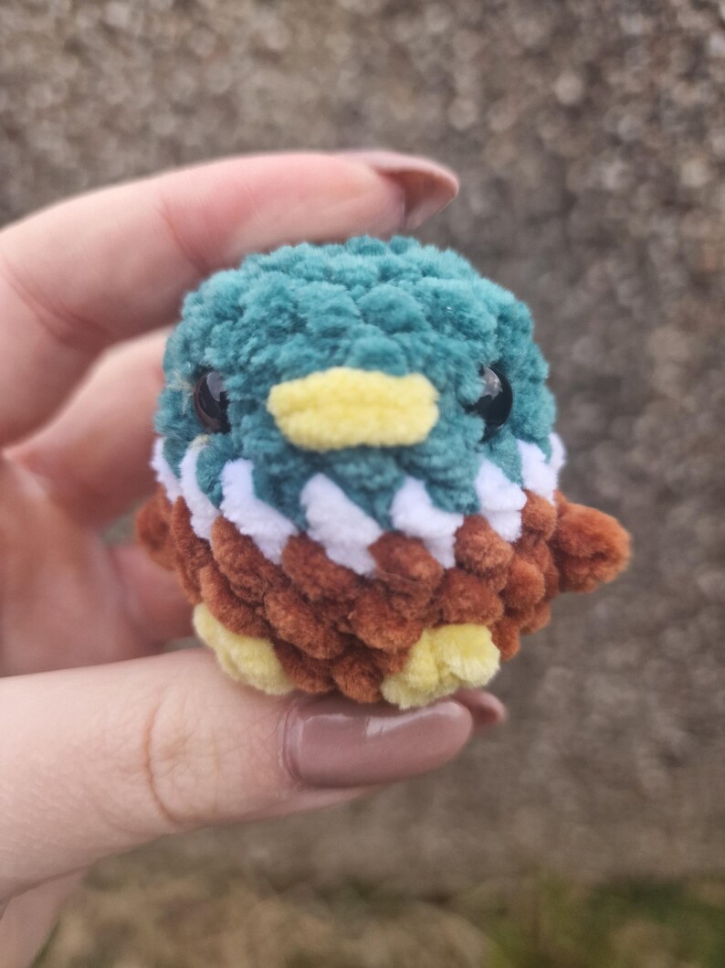 Close-up of handmade amigurumi mallard duck plush with plush chenille yarn texture