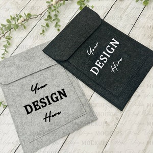 May include: Two felt laptop sleeves, one gray and one black, with a pocket on the front. Both sleeves have the text "Your Design Here" printed on the front.